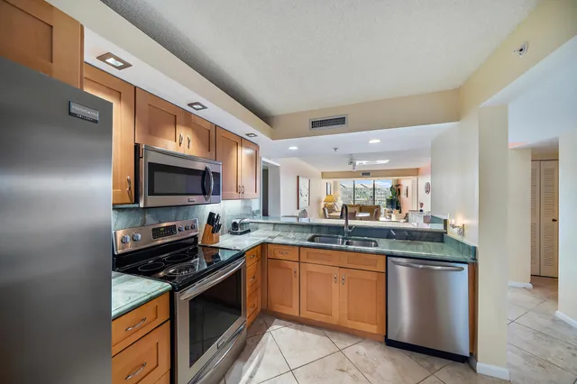 a kitchen with dining area and chandelier