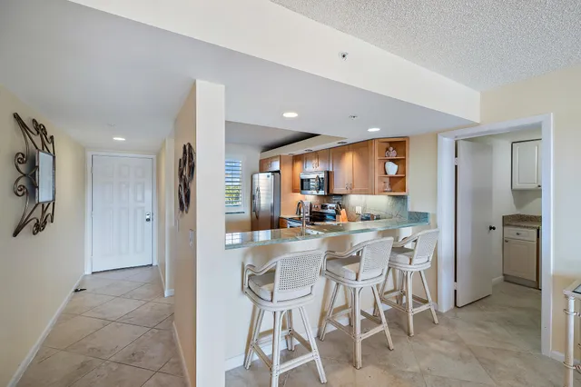 a view of a dining room with furniture large window and outside view