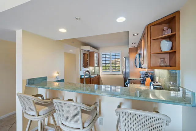 a view of a dining room with furniture and a large window