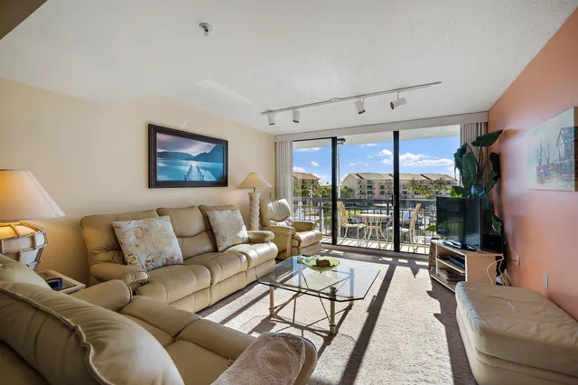 a living room with furniture and a painting