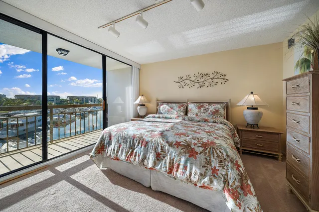 a bedroom with a large window and a balcony