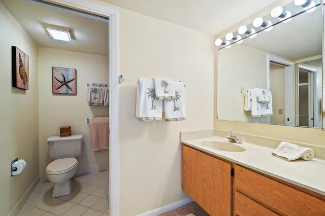 a bedroom with two beds and a flat screen tv