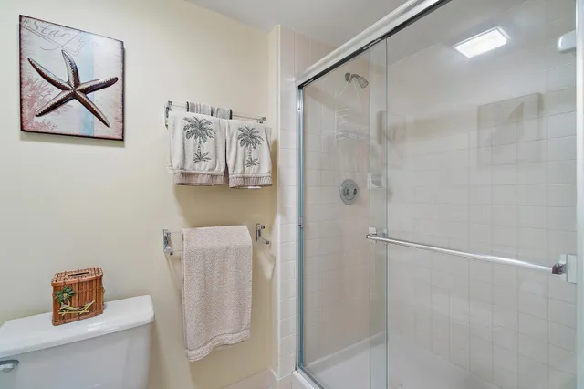 a bedroom with two beds and painting on the wall