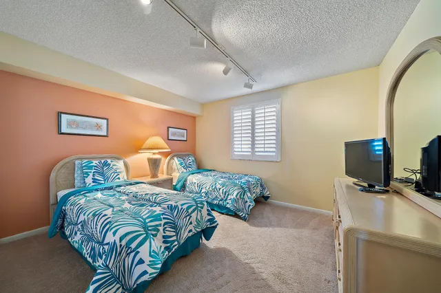 an aerial view of residential houses with outdoor space and river