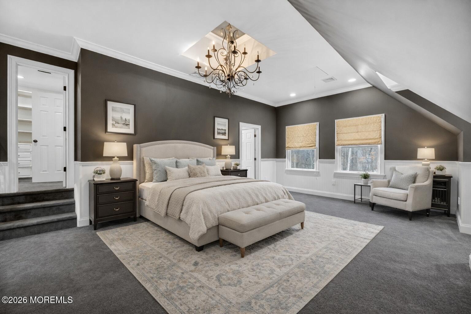 27 Carrs Tavern Road Millstone Township, NJ 08510 - Photo 28 of 78 a spacious bedroom with a large bed and a chandelier