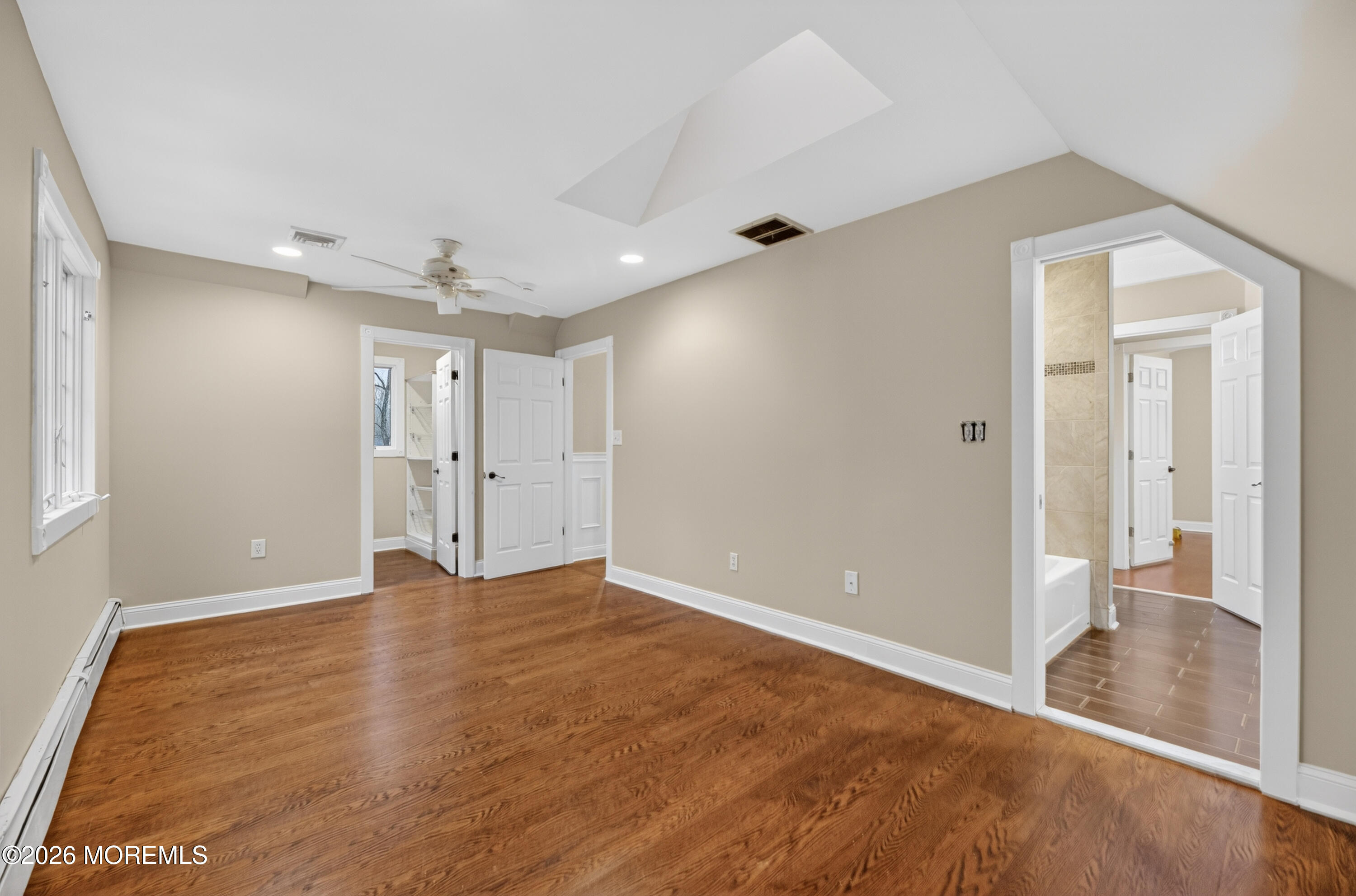 27 Carrs Tavern Road Millstone Township, NJ 08510 - Photo 45 of 78 a view of an empty room with wooden floor and a bathroom