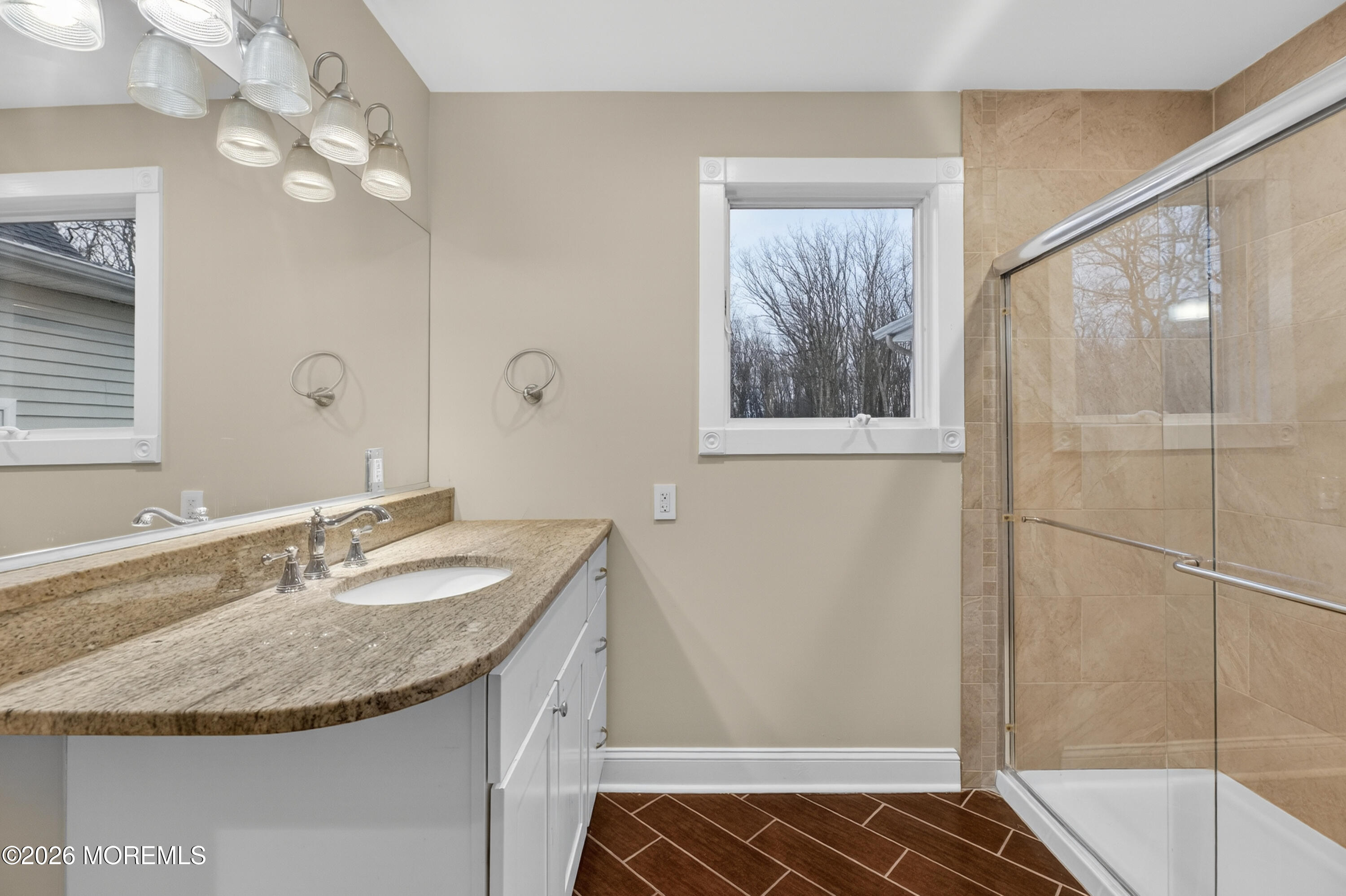 27 Carrs Tavern Road Millstone Township, NJ 08510 - Photo 53 of 78 a bathroom with a granite countertop sink a mirror and shower