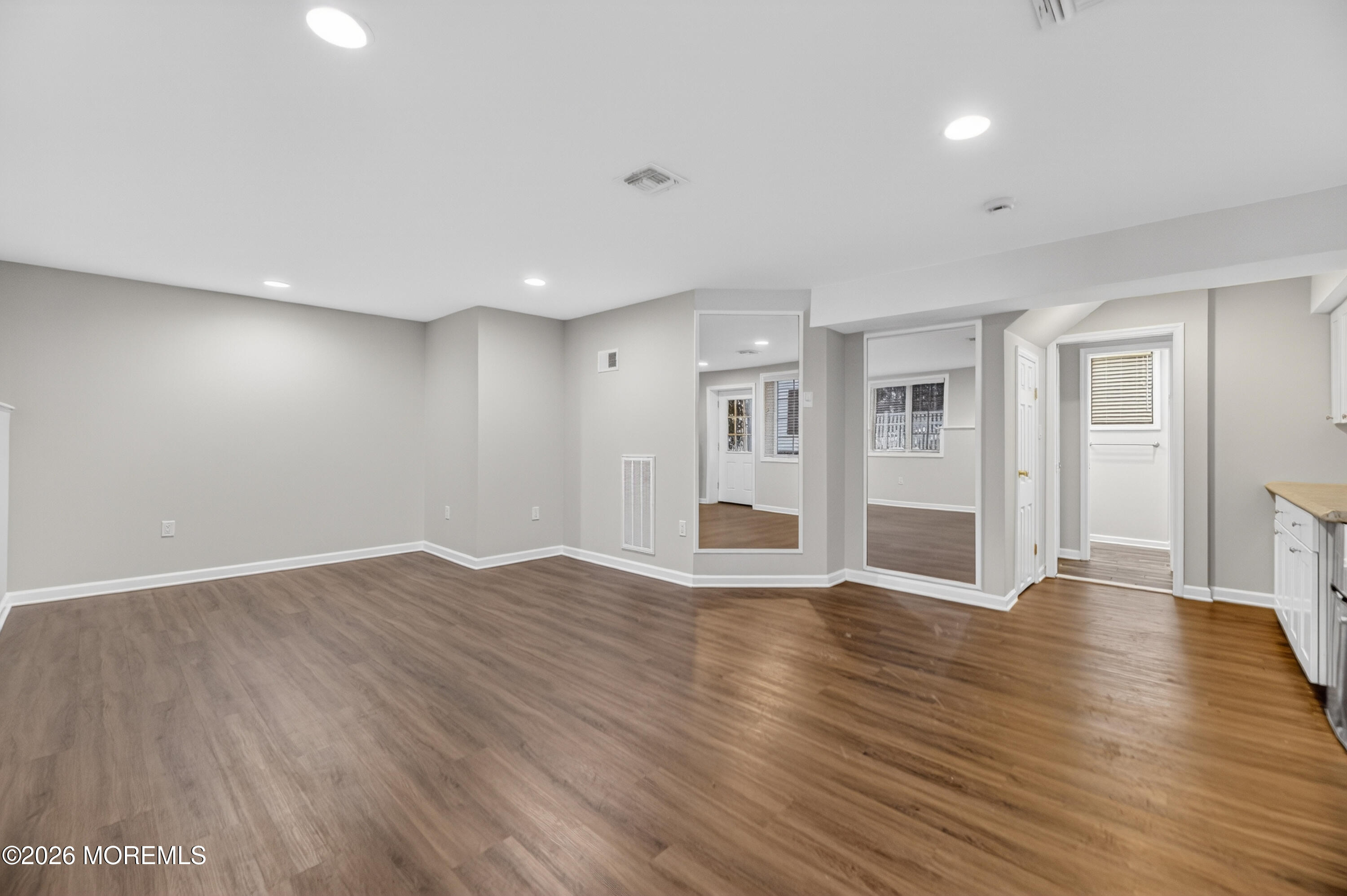 27 Carrs Tavern Road Millstone Township, NJ 08510 - Photo 59 of 78 a view of an empty room with wooden floor