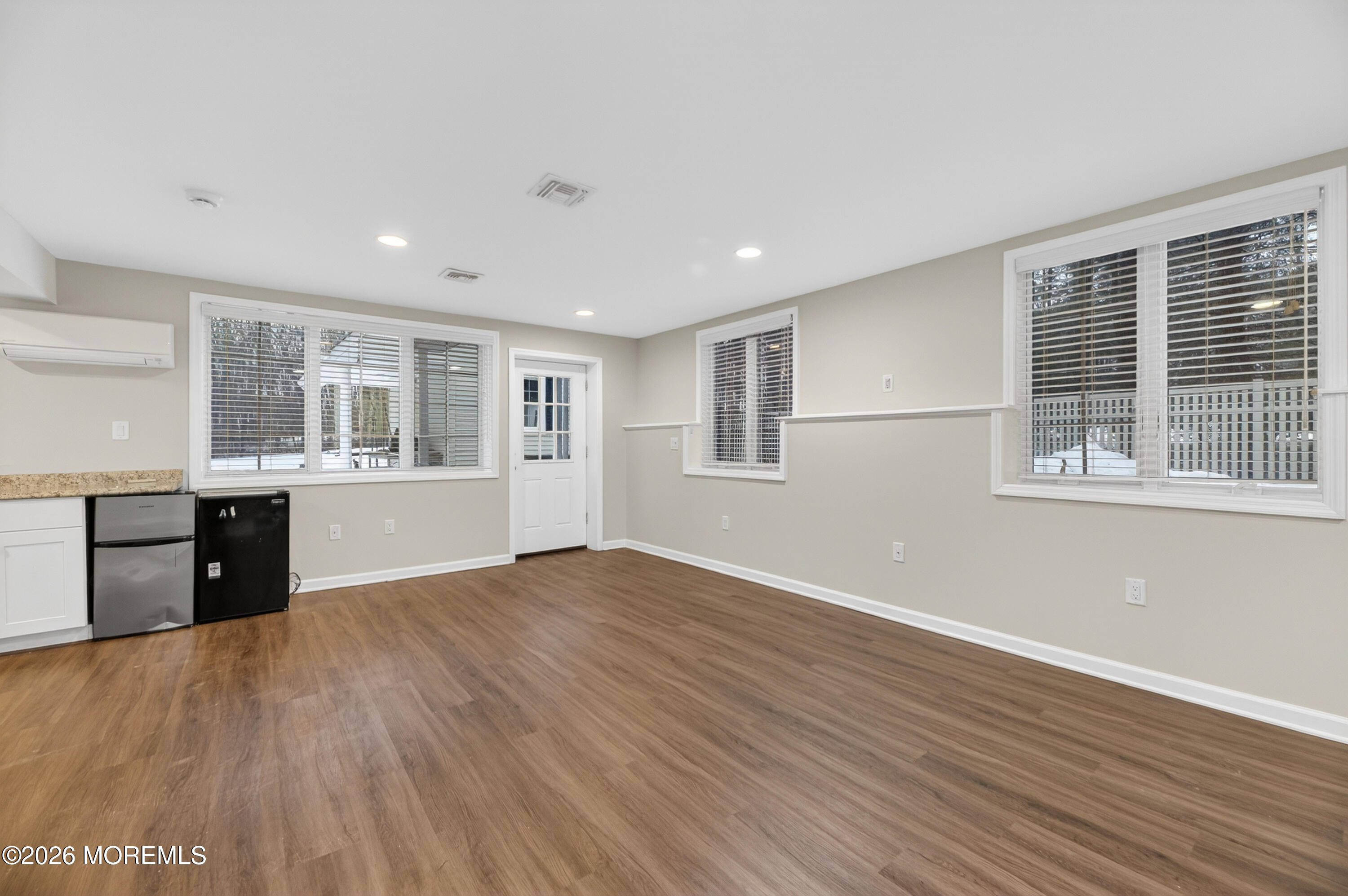 27 Carrs Tavern Road Millstone Township, NJ 08510 - Photo 60 of 78 a view of an empty room with a window and wooden floor