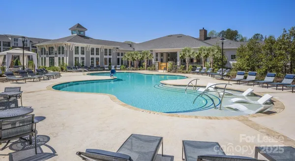 a view of a house with swimming pool and porch