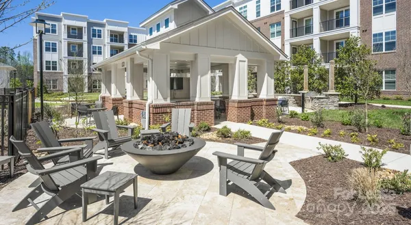 a view of a patio with couple of chairs and a fountain