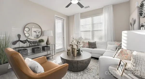 a living room with furniture a table and a large window
