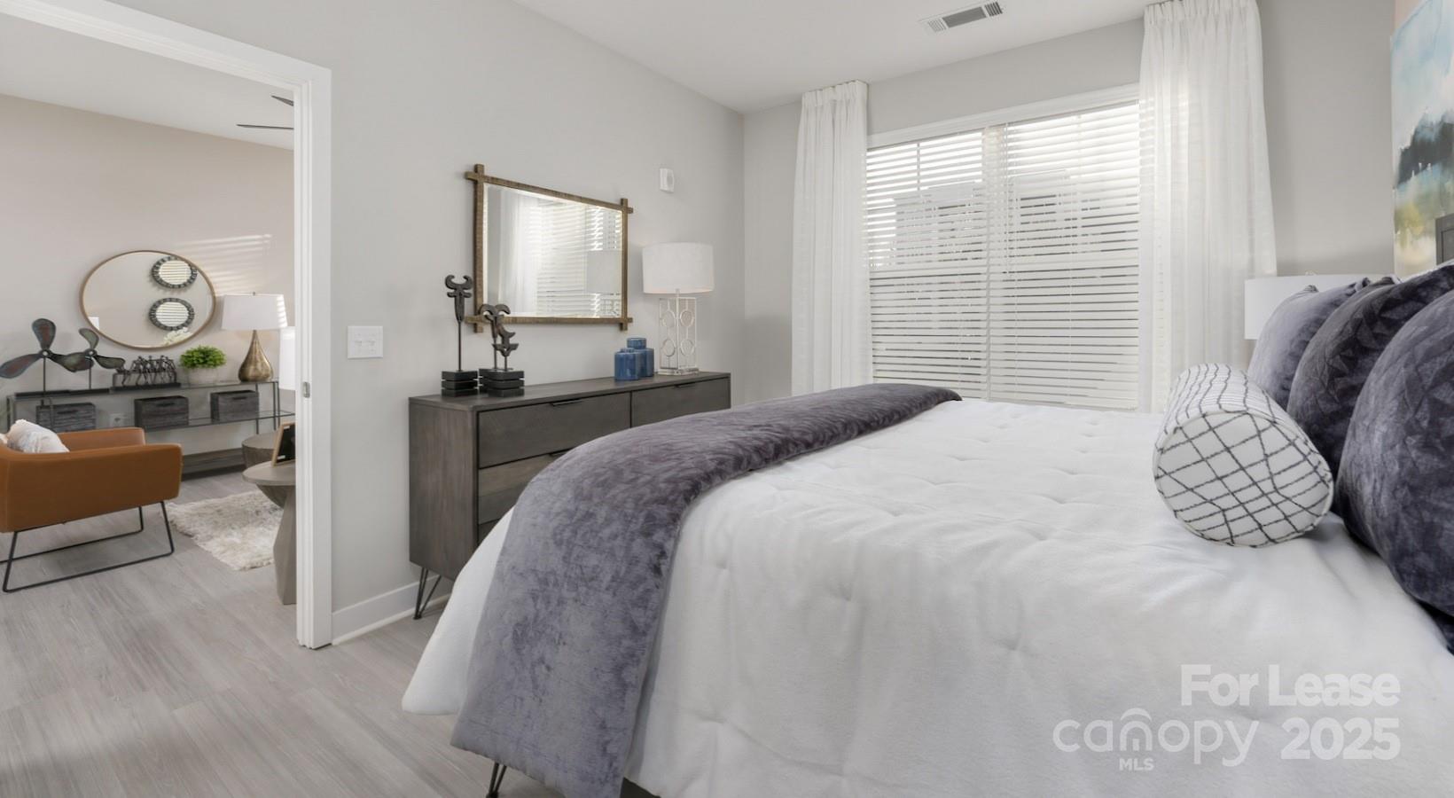 4010 Waiting Street, Unit B1 Matthews, NC 28105 - Photo 18 of 38 a bedroom with a bed and a table