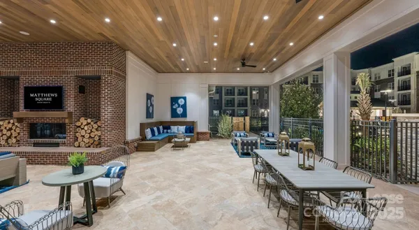 a living room with furniture a flat screen tv and a large window