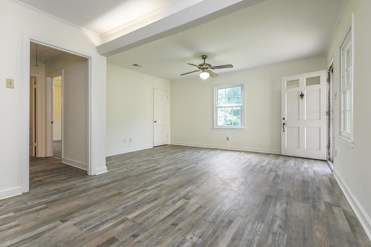 4934 Byron Road Memphis, TN 38122 - Photo 6 of 25 Empty room with ornamental molding, ceiling fan, and dark wood-type flooring