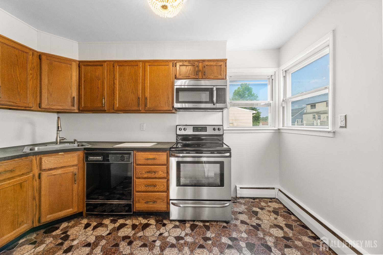 82 Mercer Street Menlo Park Terrace, NJ 08840 - Photo 12 of 31 a kitchen with stainless steel appliances granite countertop a stove and a sink