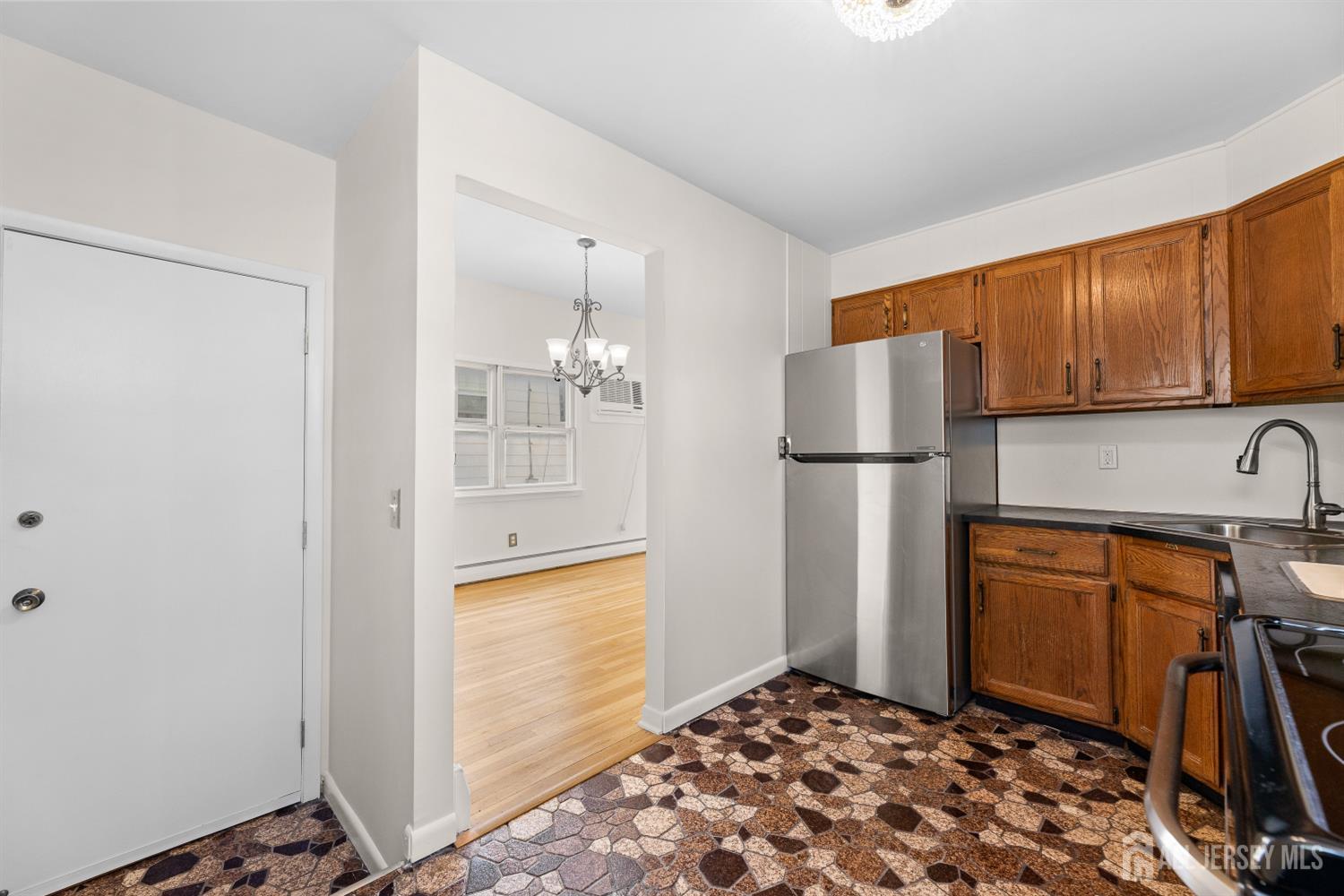 82 Mercer Street Menlo Park Terrace, NJ 08840 - Photo 13 of 31 a kitchen with stainless steel appliances granite countertop a refrigerator and a stove top oven