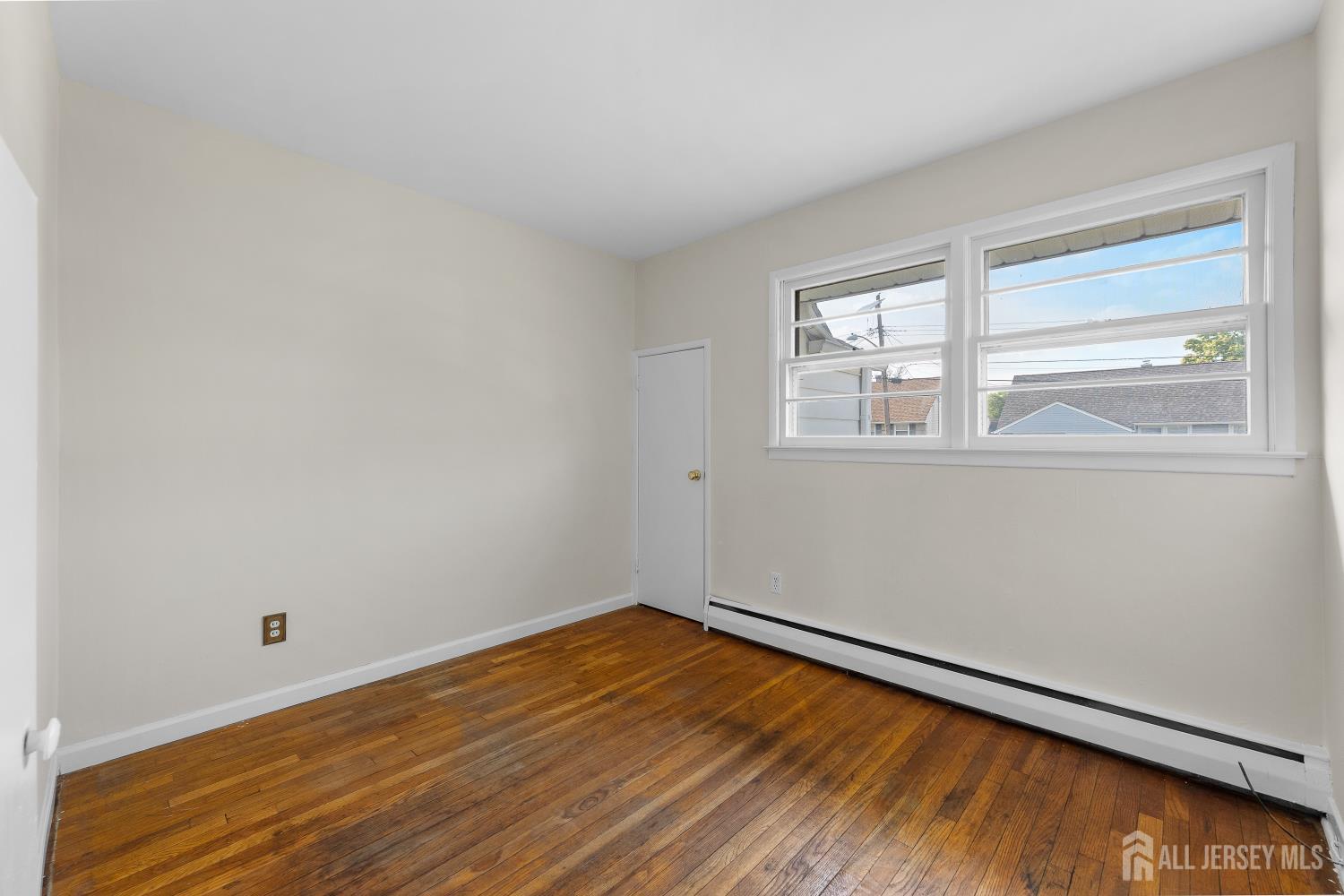 82 Mercer Street Menlo Park Terrace, NJ 08840 - Photo 15 of 31 wooden floor in an empty room with a window