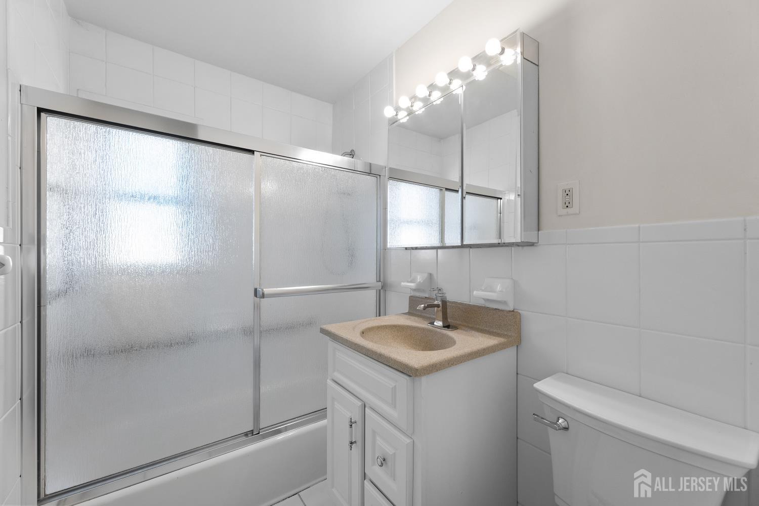 82 Mercer Street Menlo Park Terrace, NJ 08840 - Photo 17 of 31 a bathroom with a sink toilet and shower