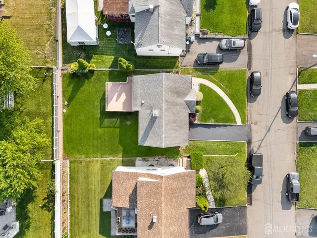 an aerial view of residential houses with outdoor space and swimming pool
