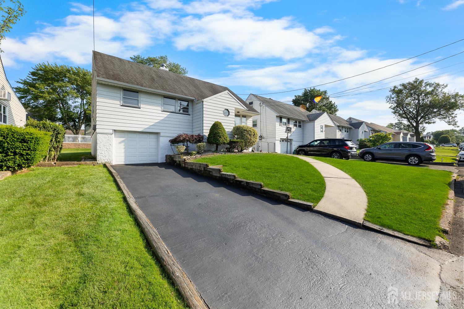 82 Mercer Street Menlo Park Terrace, NJ 08840 - Photo 3 of 31 a view of a house with a yard and garage