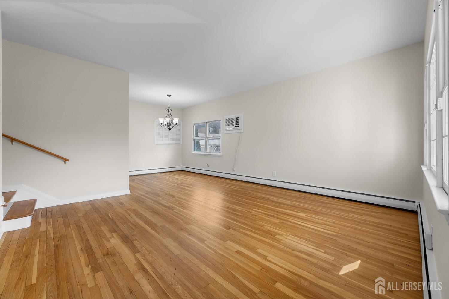 82 Mercer Street Menlo Park Terrace, NJ 08840 - Photo 6 of 31 a view of empty room with wooden floor and fan