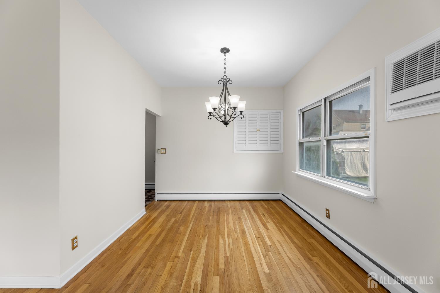 82 Mercer Street Menlo Park Terrace, NJ 08840 - Photo 8 of 31 a view of empty room with wooden floor and fan