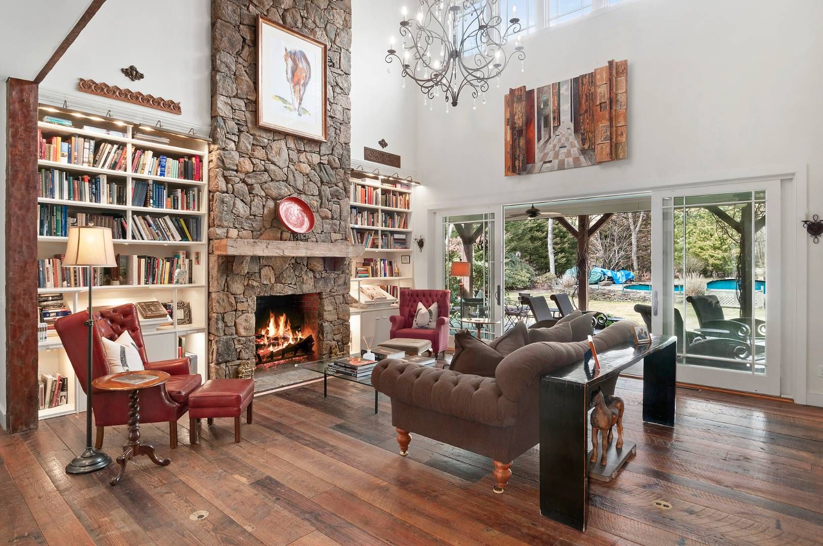 118 NW Path Sagaponack, NY 11962 - Photo 5 of 18 a living room with furniture a fireplace and a floor to ceiling window