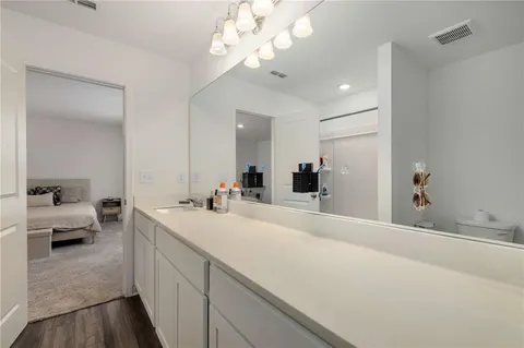 a spacious bathroom with a double vanity sink and a mirror