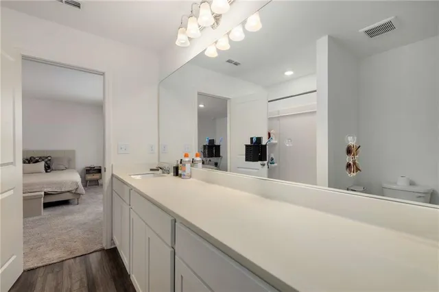 a spacious bathroom with a double vanity sink and a mirror