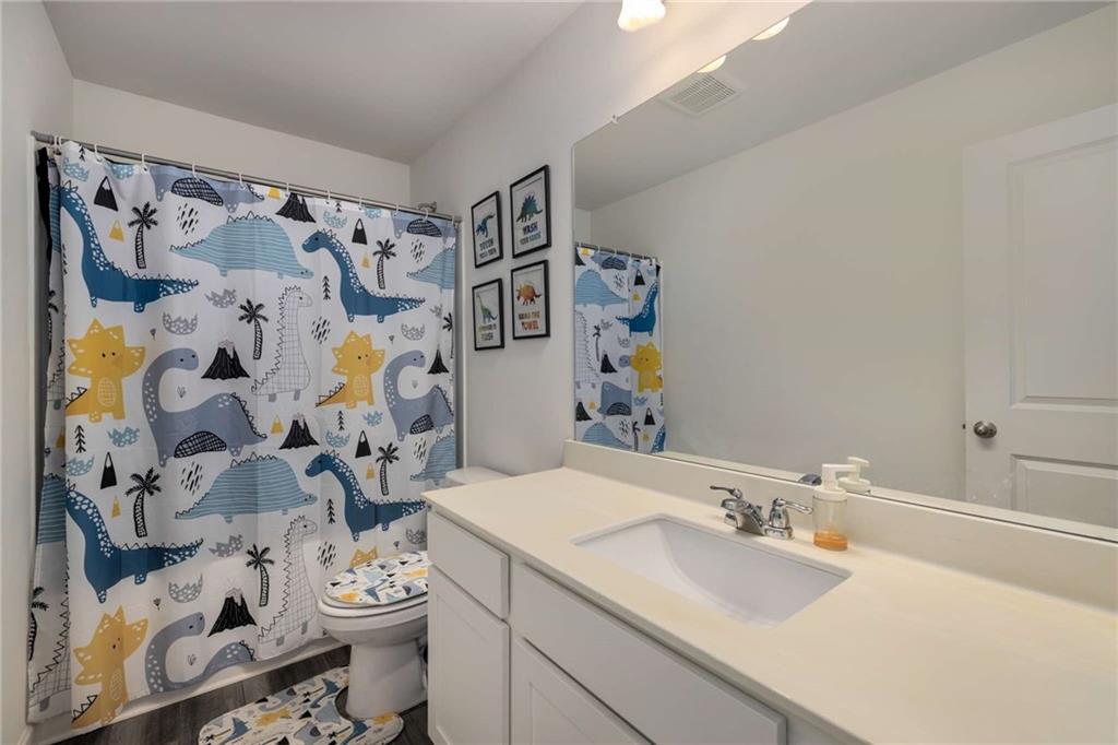 198 Colbury Street Villa Rica, GA 30180 - Photo 15 of 28 a bathroom with a sink toilet and shower curtain