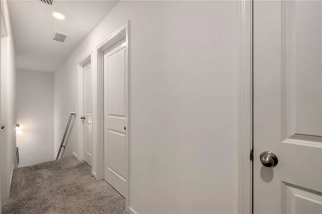 a view of a bathroom from a hallway