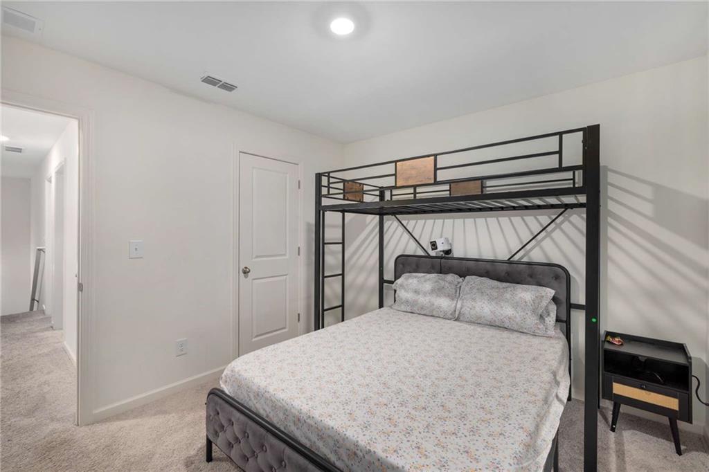 198 Colbury Street Villa Rica, GA 30180 - Photo 21 of 28 a bedroom with a bed and a chandelier