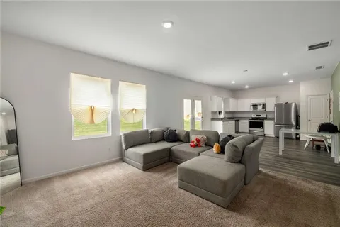 a living room with furniture and a large window