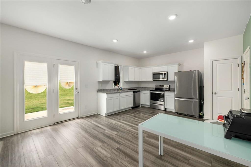 198 Colbury Street Villa Rica, GA 30180 - Photo 7 of 28 a kitchen with stainless steel appliances a refrigerator and wooden floor