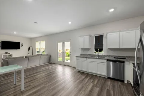 a large kitchen with a large counter top appliances and cabinets