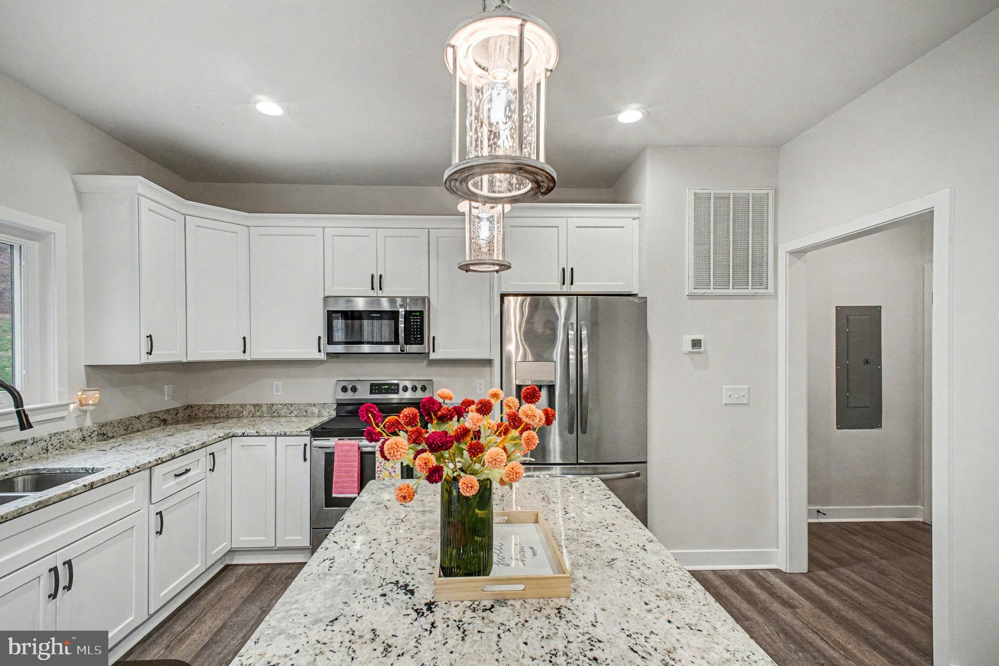 580 Kellogg Mill Road Fredericksburg, VA 22406 - Photo 11 of 41 a kitchen with stainless steel appliances granite countertop a refrigerator and a stove top oven