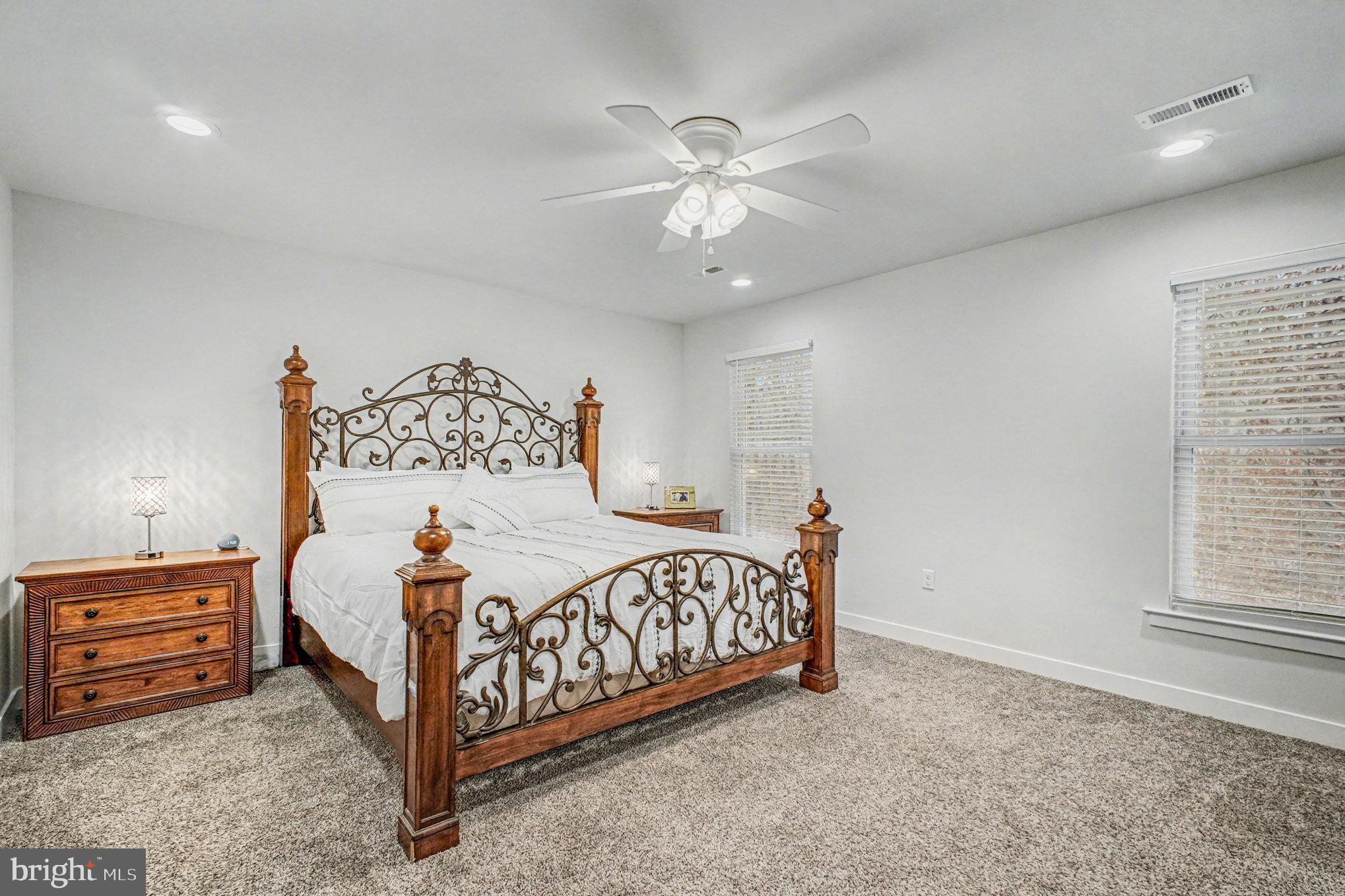 580 Kellogg Mill Road Fredericksburg, VA 22406 - Photo 15 of 41 a bedroom with a bed and a chandelier