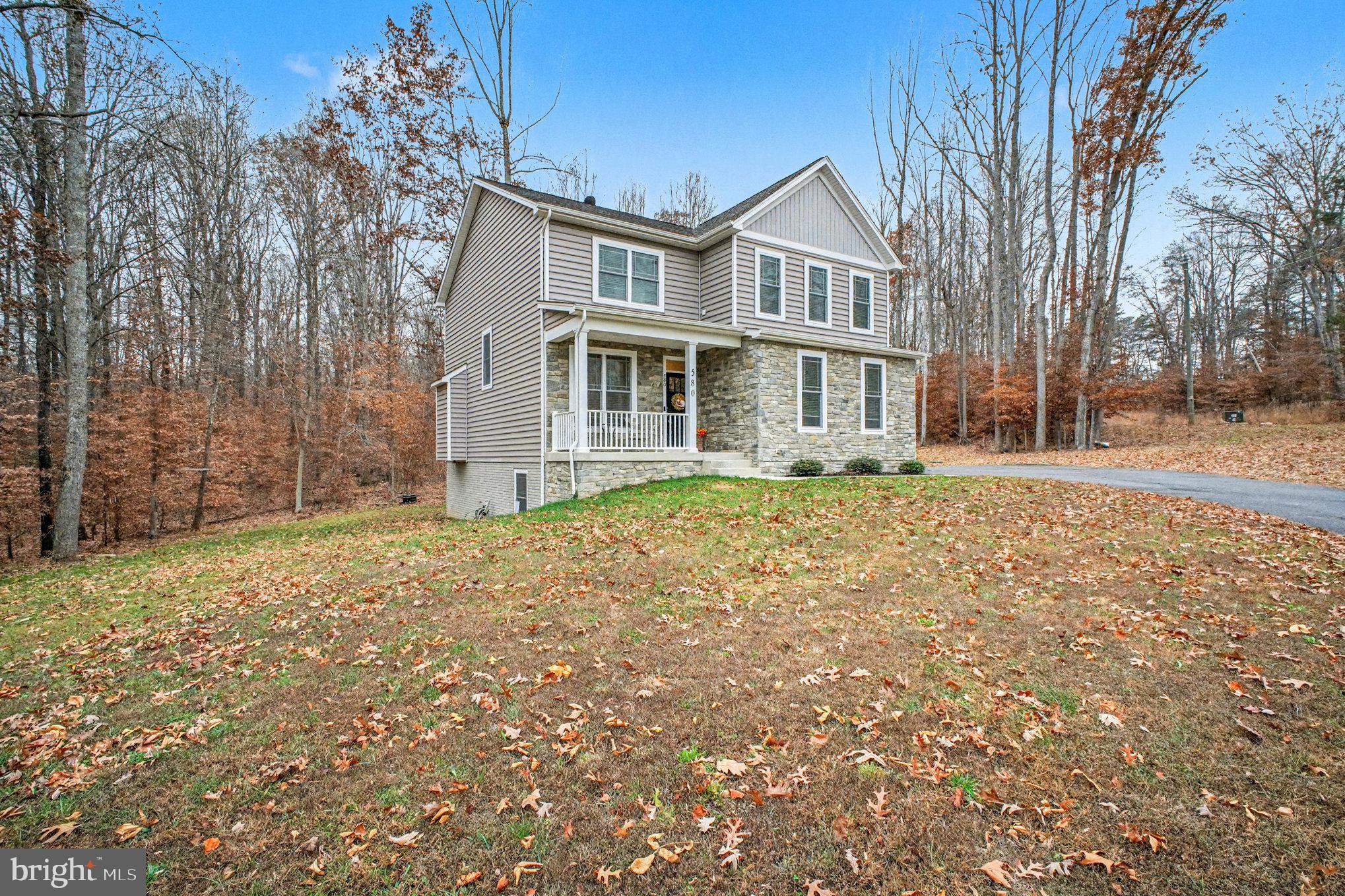 580 Kellogg Mill Road Fredericksburg, VA 22406 - Photo 2 of 41 a front view of a house with a garden