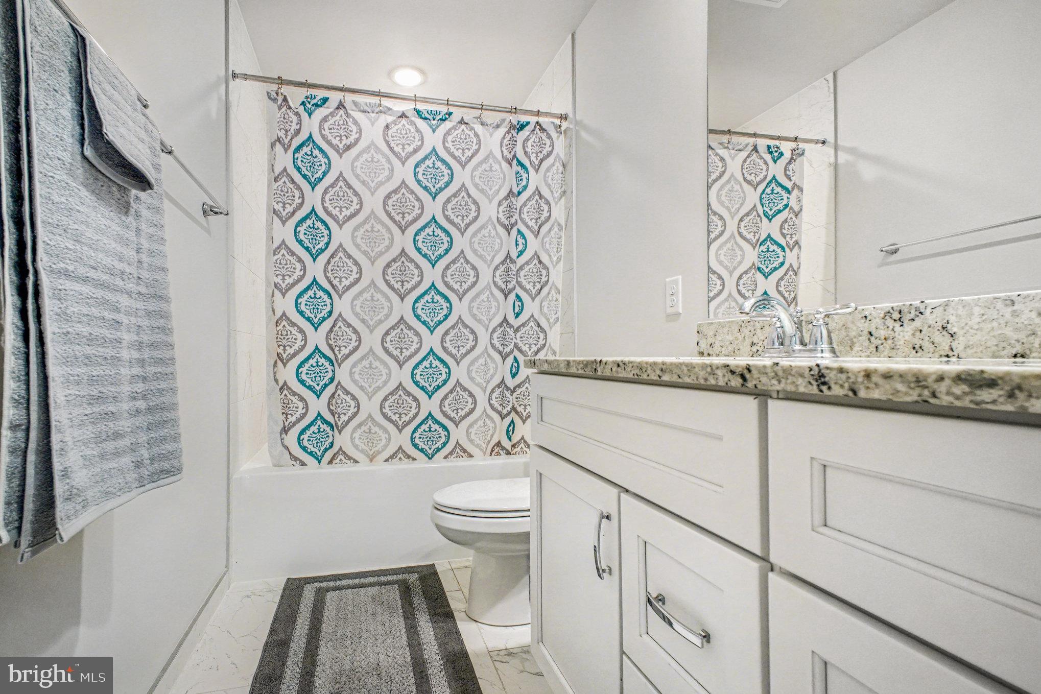 580 Kellogg Mill Road Fredericksburg, VA 22406 - Photo 23 of 41 a bathroom with a granite countertop toilet sink and mirror