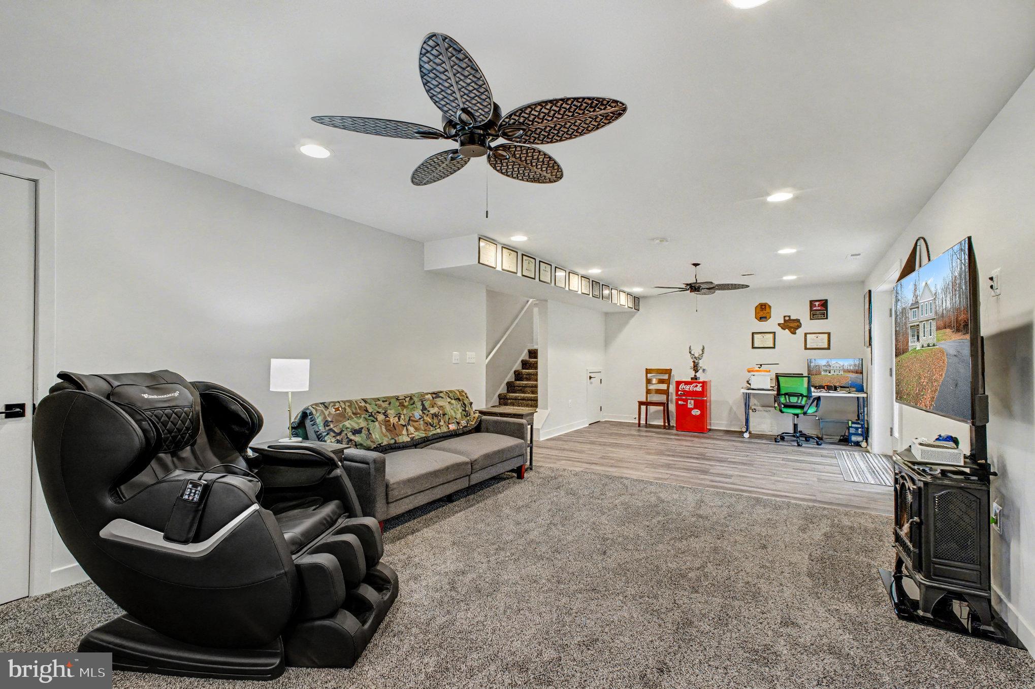 580 Kellogg Mill Road Fredericksburg, VA 22406 - Photo 25 of 41 a living room with furniture a ceiling fan and a window