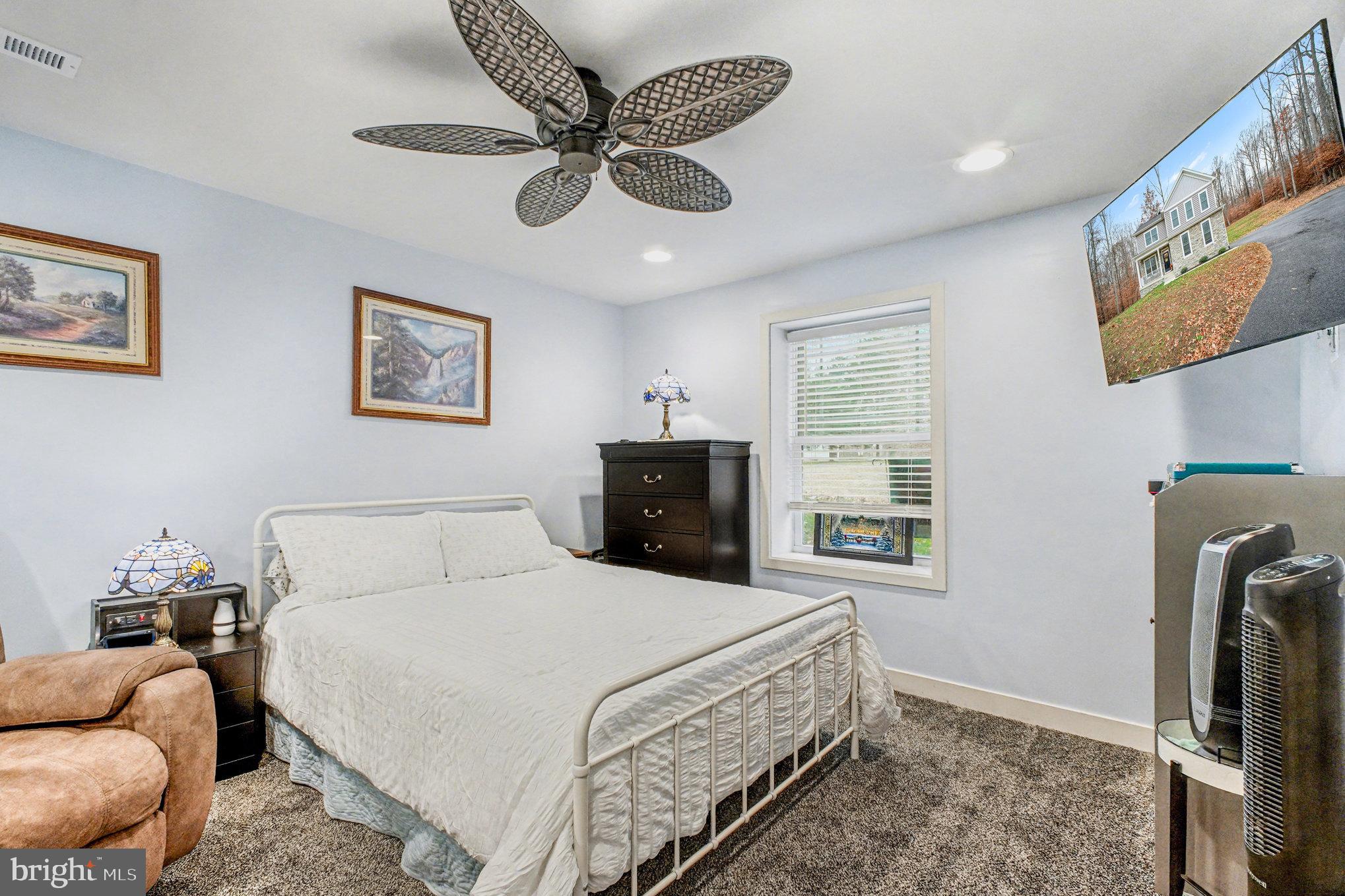 580 Kellogg Mill Road Fredericksburg, VA 22406 - Photo 28 of 41 a bedroom with a bed and painting on the wall