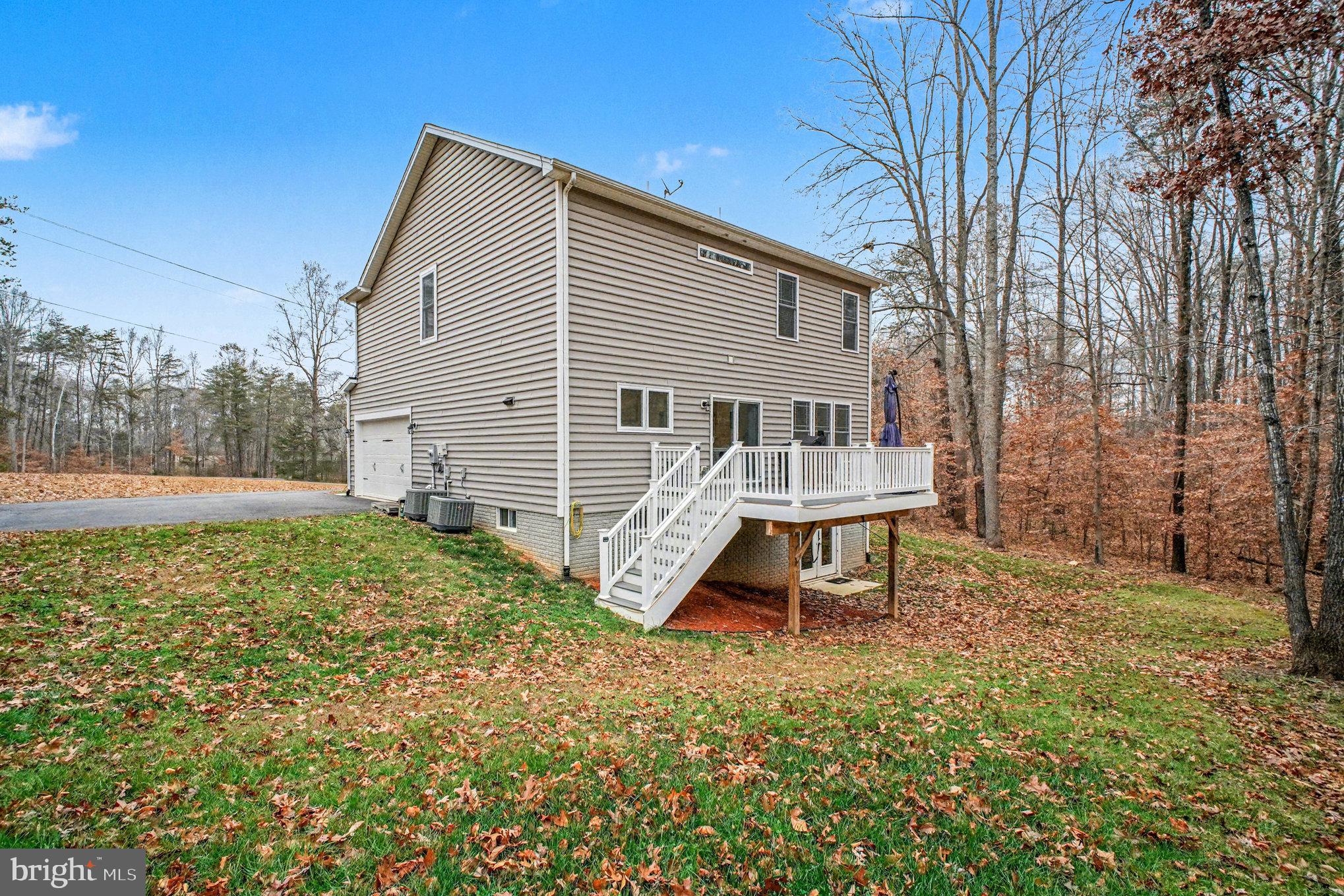 580 Kellogg Mill Road Fredericksburg, VA 22406 - Photo 34 of 41 a view of a house with a yard and sitting area