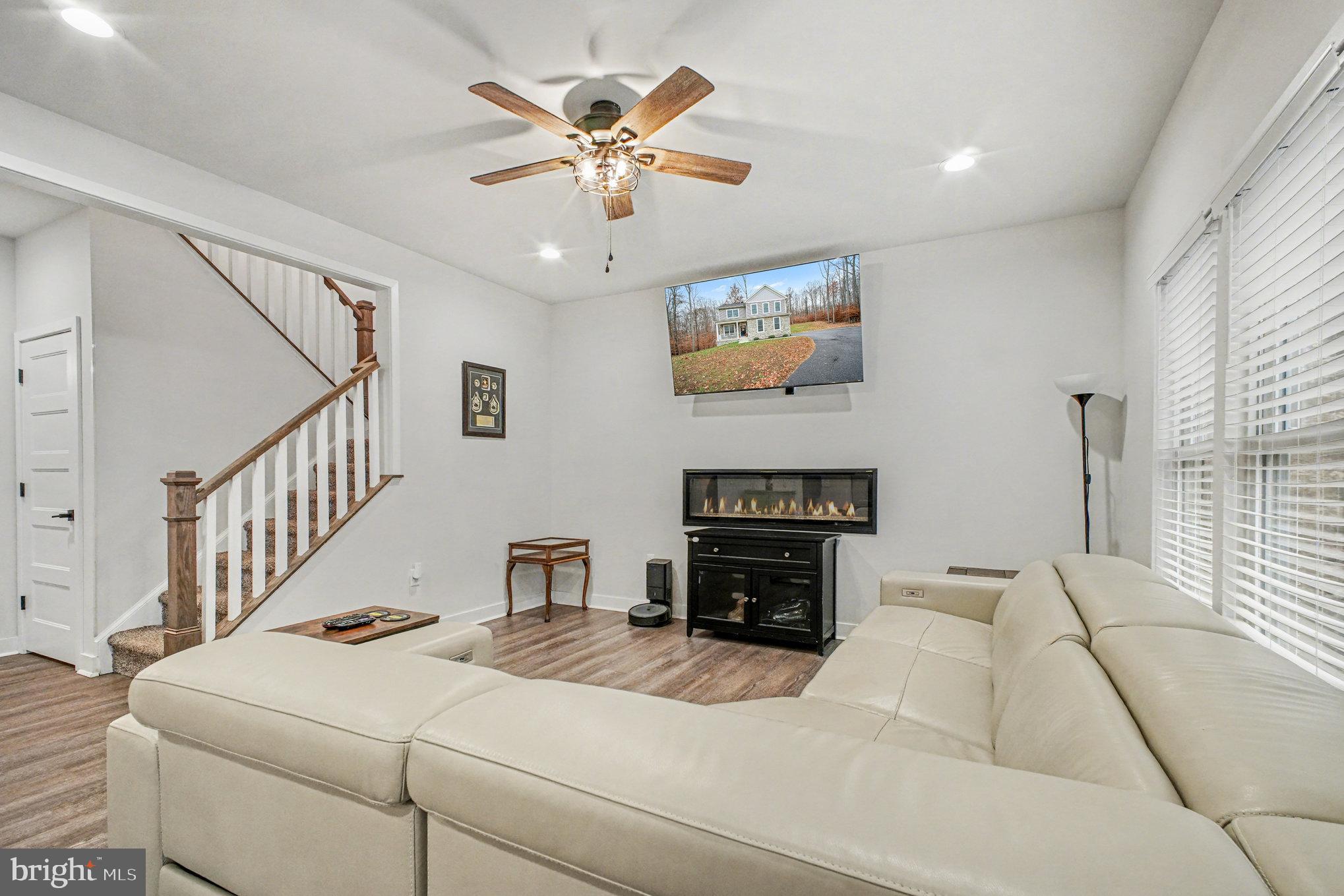 580 Kellogg Mill Road Fredericksburg, VA 22406 - Photo 6 of 41 a living room with furniture a fireplace and a flat screen tv