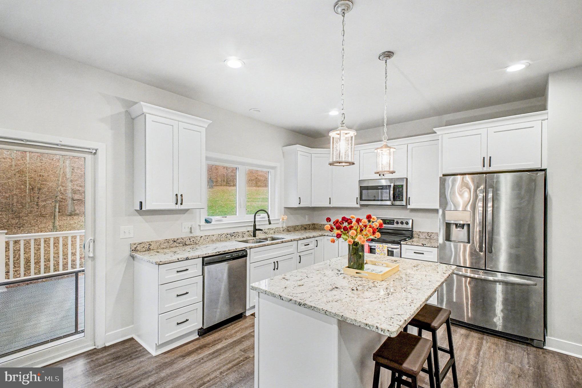 580 Kellogg Mill Road Fredericksburg, VA 22406 - Photo 9 of 41 a kitchen with granite countertop a center island stainless steel appliances cabinets and a window