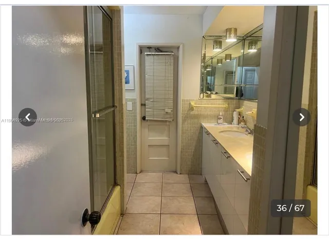 a bathroom with a glass shower door
