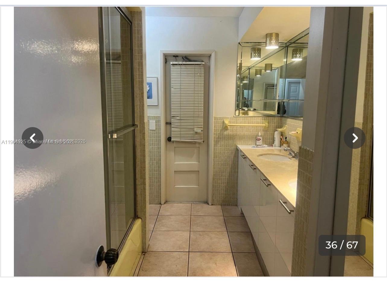 5001 Madison Street Hollywood, FL 33021 - Photo 13 of 23 a bathroom with a glass shower door