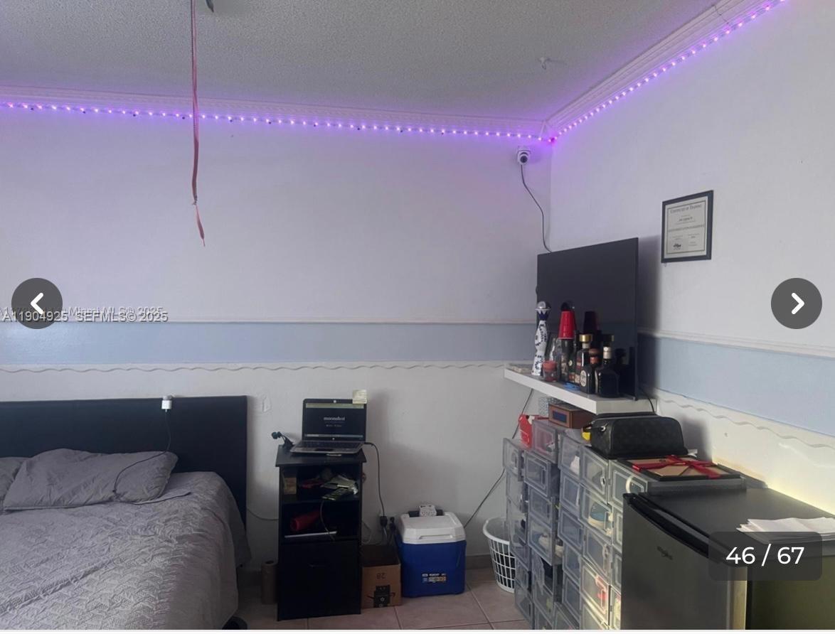 5001 Madison Street Hollywood, FL 33021 - Photo 15 of 23 a room with furniture and a flat screen tv