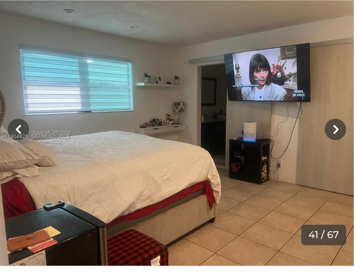 5001 Madison Street Hollywood, FL 33021 - Photo 17 of 23 a bedroom with a bed and a painting on the wall