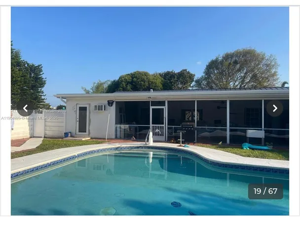 a swimming pool with outdoor seating and yard